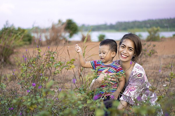 mother holding child in field